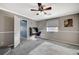 Bedroom with gray carpet, ceiling fan, and built-in desk at 10191 Cougar Crossing St, Las Vegas, NV 89178