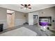 Bedroom with gray carpet, ceiling fan, and built-in desk at 10191 Cougar Crossing St, Las Vegas, NV 89178