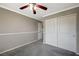 Simple bedroom with double door closet and ceiling fan at 10191 Cougar Crossing St, Las Vegas, NV 89178