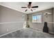 Cozy bedroom with a ceiling fan and a large window at 10191 Cougar Crossing St, Las Vegas, NV 89178