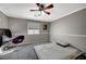 Spacious bedroom with gray carpet, ceiling fan and window at 10191 Cougar Crossing St, Las Vegas, NV 89178