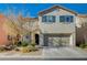 Two-story house with attached garage and landscaping at 10191 Cougar Crossing St, Las Vegas, NV 89178