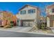 Two-story house with attached garage and landscaping at 10191 Cougar Crossing St, Las Vegas, NV 89178