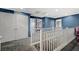 Upstairs hallway with gray carpet, white railings, and blue walls at 10191 Cougar Crossing St, Las Vegas, NV 89178