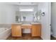 Bathroom with double sinks, mirror, and bathtub at 10441 Concetta Ave, Las Vegas, NV 89129