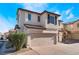 Two-story house with tan exterior, brown roof, and a two-car garage at 10441 Concetta Ave, Las Vegas, NV 89129