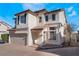 Two-story house with tan exterior, brown roof, and a two-car garage at 10441 Concetta Ave, Las Vegas, NV 89129