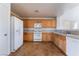 Kitchen with light wood cabinets, white appliances, and tile floor at 10441 Concetta Ave, Las Vegas, NV 89129