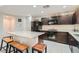 Modern kitchen with granite countertops and dark wood cabinets at 10548 Seasonable Dr, Las Vegas, NV 89129