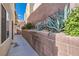 Landscaped walkway with desert plants and brick wall at 10548 Seasonable Dr, Las Vegas, NV 89129