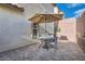 Small patio with table, chairs, and umbrella at 10548 Seasonable Dr, Las Vegas, NV 89129