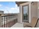 Private balcony with a door and chair, overlooks a street at 10691 Sariah Skye Ave, Las Vegas, NV 89166