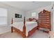 Spacious bedroom with a wooden four-poster bed and a large dresser at 10691 Sariah Skye Ave, Las Vegas, NV 89166