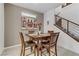 Small dining area with dark wood table and four leather chairs at 10691 Sariah Skye Ave, Las Vegas, NV 89166