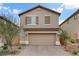 Two-story house with brown garage door and landscaping at 10691 Sariah Skye Ave, Las Vegas, NV 89166