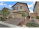 Two-story house with brown garage door and landscaping at 10691 Sariah Skye Ave, Las Vegas, NV 89166