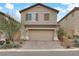 Two-story house with brown garage door and landscaping at 10691 Sariah Skye Ave, Las Vegas, NV 89166