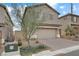 Two-story house with brown garage door and landscaping at 10691 Sariah Skye Ave, Las Vegas, NV 89166