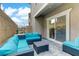 Outdoor patio with turquoise furniture and sitting area at 10691 Sariah Skye Ave, Las Vegas, NV 89166