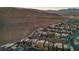 Aerial view of a community of contemporary homes nestled against a mountain backdrop at 10896 Tranquil Hills Way, Las Vegas, NV 89135