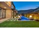 Modern home with a luxurious pool and patio area at night at 10896 Tranquil Hills Way, Las Vegas, NV 89135