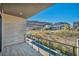 Stylish balcony view with a pool and desert landscape beyond modern homes, perfect for relaxation at 10896 Tranquil Hills Way, Las Vegas, NV 89135