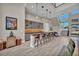 Modern home bar with glass cabinets, gold tile backsplash, and barstools at 10896 Tranquil Hills Way, Las Vegas, NV 89135