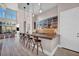 Home bar with glass-front cabinets, quartz countertops and barstools at 10896 Tranquil Hills Way, Las Vegas, NV 89135