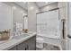 Modern bathroom featuring a sleek vanity, tub with shower, and neutral color palette at 10896 Tranquil Hills Way, Las Vegas, NV 89135