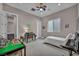 Bright bedroom featuring a bed, desk, and built-in shelving at 10896 Tranquil Hills Way, Las Vegas, NV 89135