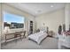 Sunlit bedroom with a large window, desk, and a cozy bed, creating a peaceful retreat at 10896 Tranquil Hills Way, Las Vegas, NV 89135