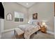 Bright bedroom with a queen-size bed and sitting bench at 10896 Tranquil Hills Way, Las Vegas, NV 89135