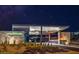 Nighttime view of the gated entrance to the Mesa Ridge community with illuminated signage at 10896 Tranquil Hills Way, Las Vegas, NV 89135