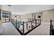 Bright second floor hallway with metal railings and natural light at 10896 Tranquil Hills Way, Las Vegas, NV 89135