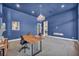 Modern home office with blue walls, fireplace, and wood desk at 10896 Tranquil Hills Way, Las Vegas, NV 89135