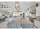 Open kitchen with a large marble island, stainless steel appliances, and modern pendant lighting at 10896 Tranquil Hills Way, Las Vegas, NV 89135