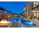 Luxury backyard with a pool and fire pit, illuminated at night at 10896 Tranquil Hills Way, Las Vegas, NV 89135