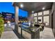 Modern outdoor kitchen with stainless steel appliances and stone countertops at 10896 Tranquil Hills Way, Las Vegas, NV 89135