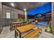 Modern outdoor kitchen and dining area with a view of the pool at 10896 Tranquil Hills Way, Las Vegas, NV 89135