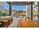 Covered outdoor patio with modern seating, a bar, and views of the pool and upscale neighborhood at 10896 Tranquil Hills Way, Las Vegas, NV 89135