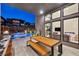 Alfresco dining area with a large wooden table overlooking the pool at 10896 Tranquil Hills Way, Las Vegas, NV 89135