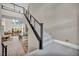 Modern staircase with carpeted steps, metal railings, and view of the open-concept living area at 10896 Tranquil Hills Way, Las Vegas, NV 89135