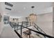 Modern upper hallway with chandelier, overlooking pool and kitchen at 10896 Tranquil Hills Way, Las Vegas, NV 89135