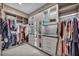 Luxurious walk-in closet with custom shelving and lighting at 10896 Tranquil Hills Way, Las Vegas, NV 89135