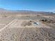 Property overview showing house, lot and surrounding desert landscape at 1411 E Blosser Ranch Rd, Pahrump, NV 89060