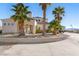 Two story house with palm trees and a stone wall at 1411 E Blosser Ranch Rd, Pahrump, NV 89060