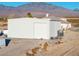 White metal garage building with large roll-up door at 1411 E Blosser Ranch Rd, Pahrump, NV 89060