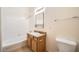 Well-lit bathroom with a tub, shower, and wood vanity at 2051 Hussium Hills St # 207, Las Vegas, NV 89108