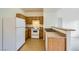 Kitchen with wood cabinets, white appliances, and granite counters at 2051 Hussium Hills St # 207, Las Vegas, NV 89108