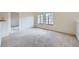 Bright living room with carpeted floors and large windows at 2051 Hussium Hills St # 207, Las Vegas, NV 89108